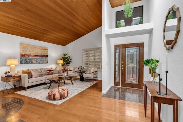 entrance foyer with wood ceiling, a healthy amount of sunlight, high vaulted ceiling, and hardwood / wood-style flooring