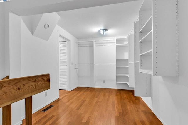 spacious closet featuring hardwood / wood-style flooring