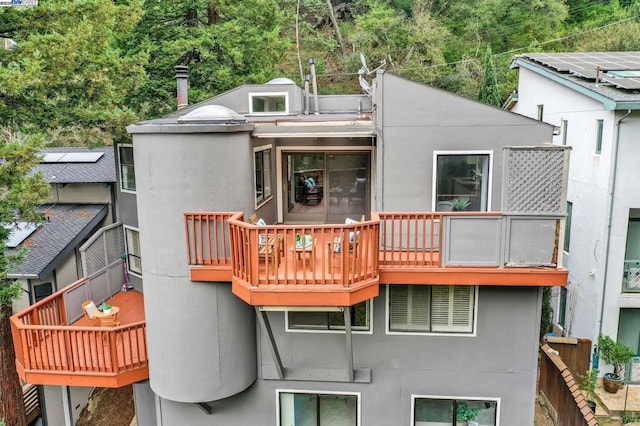 back of property with a balcony