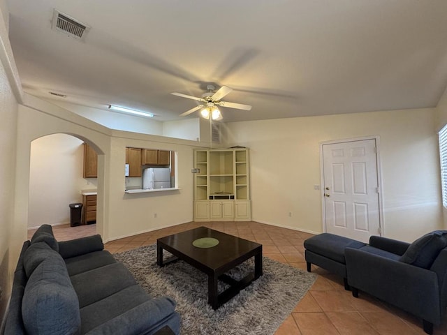 tiled living room featuring ceiling fan