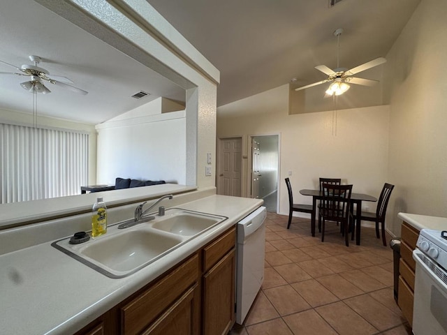 kitchen with vaulted ceiling, white appliances, ceiling fan, and sink