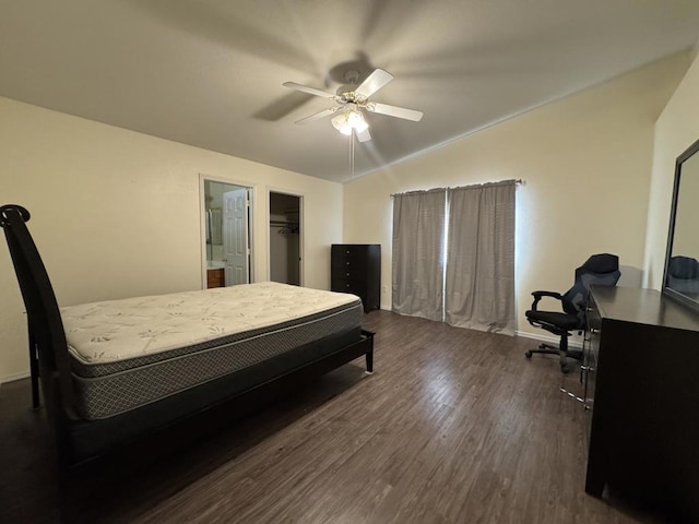 bedroom with dark hardwood / wood-style flooring, vaulted ceiling, and ceiling fan