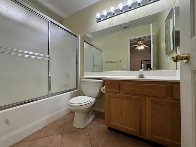 full bathroom with tile patterned flooring, vanity, shower / bath combination with glass door, and toilet