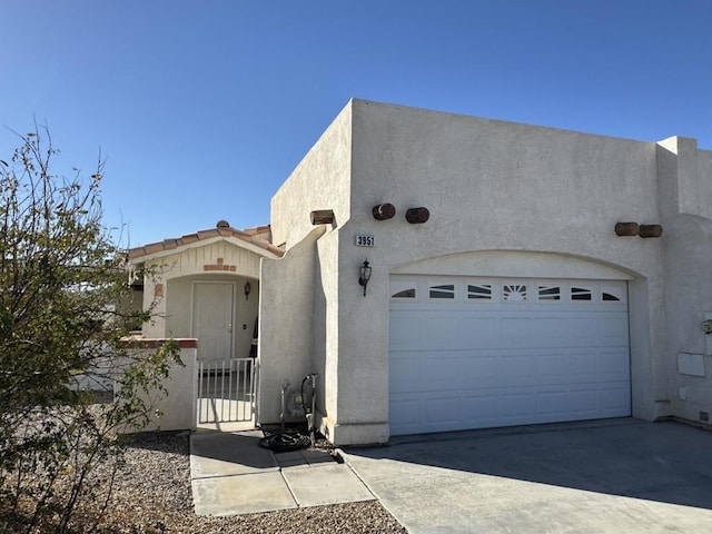 pueblo-style home with a garage