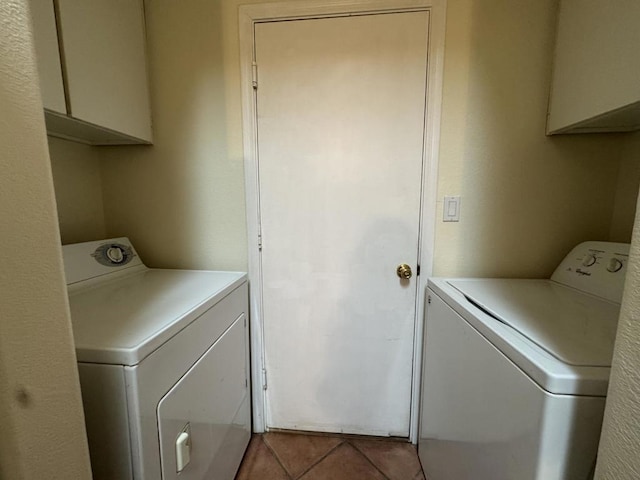 laundry area with light tile patterned flooring, cabinets, and separate washer and dryer