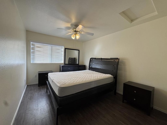 bedroom with ceiling fan and dark hardwood / wood-style flooring