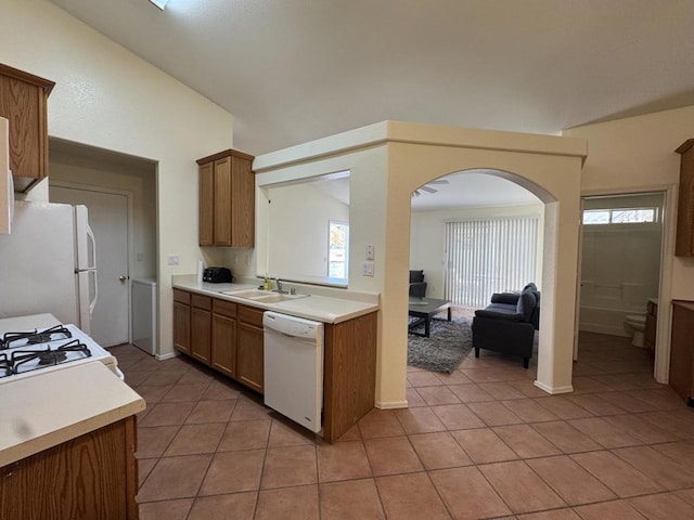 kitchen with light tile patterned flooring, white appliances, and sink