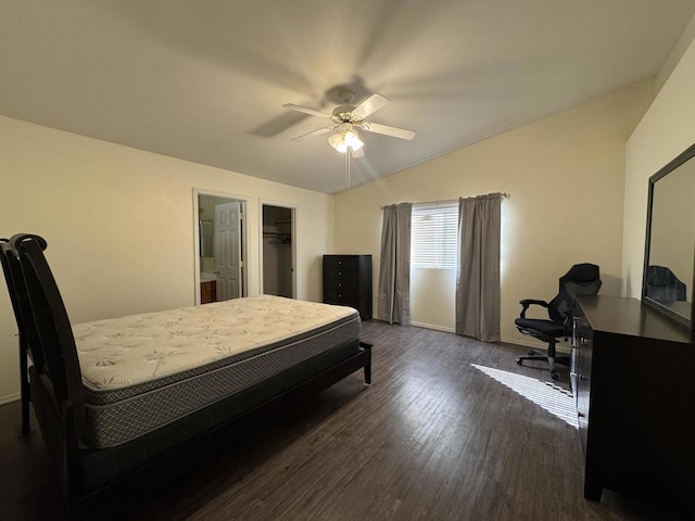 bedroom featuring dark wood-type flooring, ceiling fan, lofted ceiling, and a spacious closet