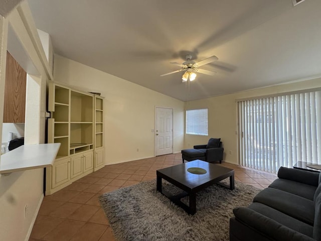 living room with vaulted ceiling, ceiling fan, and light tile patterned flooring