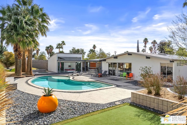 view of swimming pool with a patio area