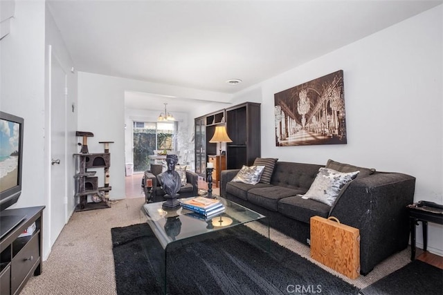 carpeted living room with a chandelier