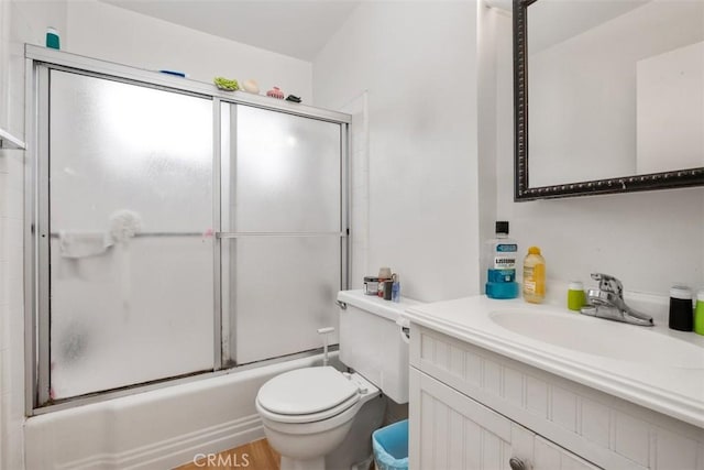 full bathroom featuring vanity, shower / bath combination with glass door, and toilet