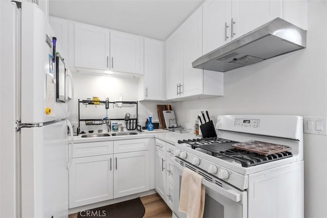 kitchen with white cabinetry, dark hardwood / wood-style flooring, sink, and white appliances