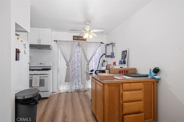 kitchen featuring white cabinetry, ceiling fan, white appliances, and light hardwood / wood-style floors