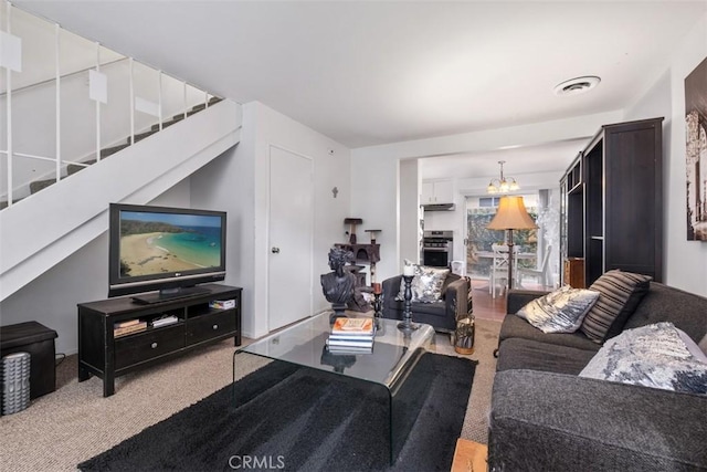 living room featuring light colored carpet and a chandelier