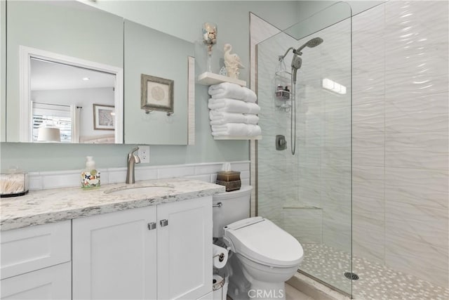 bathroom with vanity, an enclosed shower, and toilet