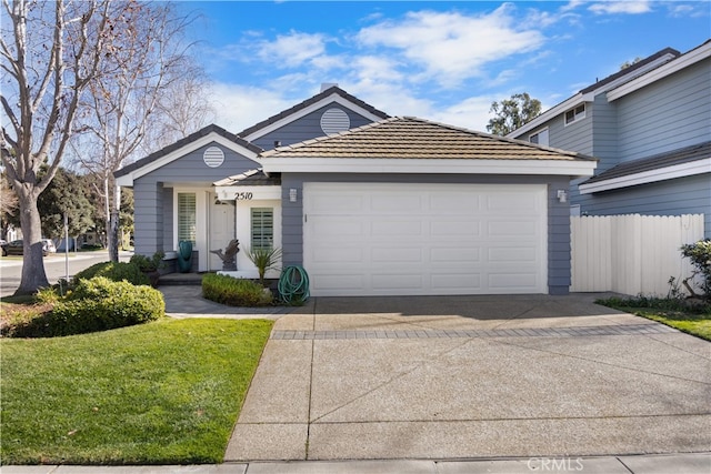 view of front of property with a garage and a front lawn