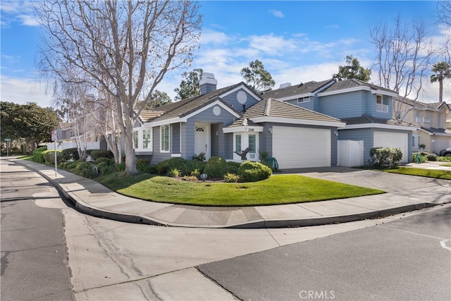 view of front of home with a garage and a front lawn