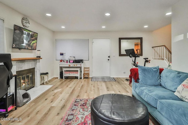 living room featuring light hardwood / wood-style floors and a premium fireplace