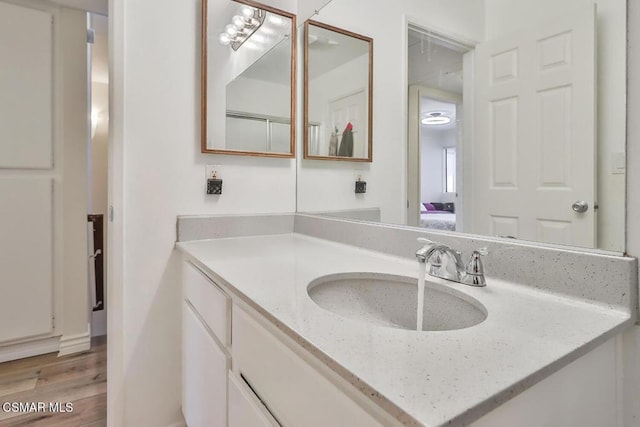 bathroom with vanity and wood-type flooring