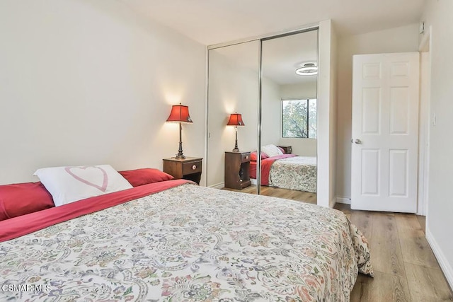 bedroom featuring light hardwood / wood-style floors and a closet