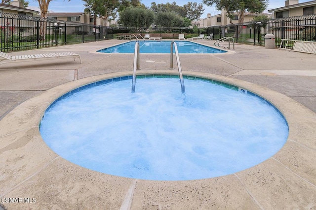 view of pool with a community hot tub