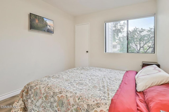 bedroom with wood-type flooring