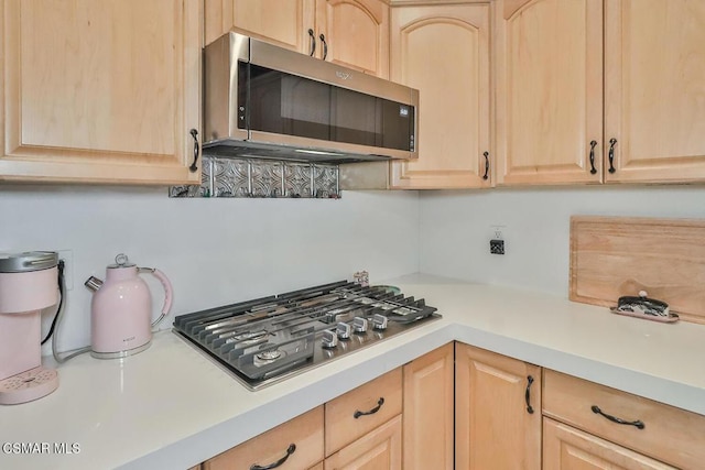 kitchen featuring light brown cabinetry and stainless steel appliances