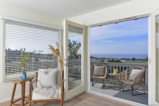 sunroom featuring a water view