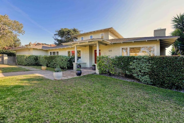 view of front of property with a lawn