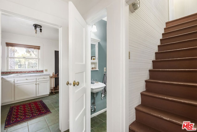 stairway with tile patterned floors