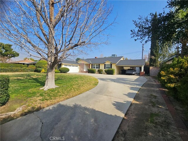 ranch-style house featuring a garage and a front lawn