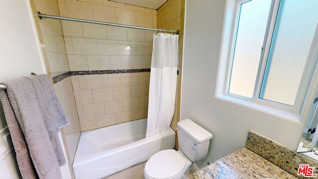 full bathroom featuring shower / tub combo with curtain, vanity, and toilet