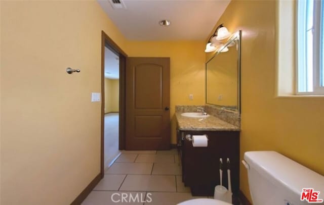 bathroom with tile patterned floors, vanity, and toilet