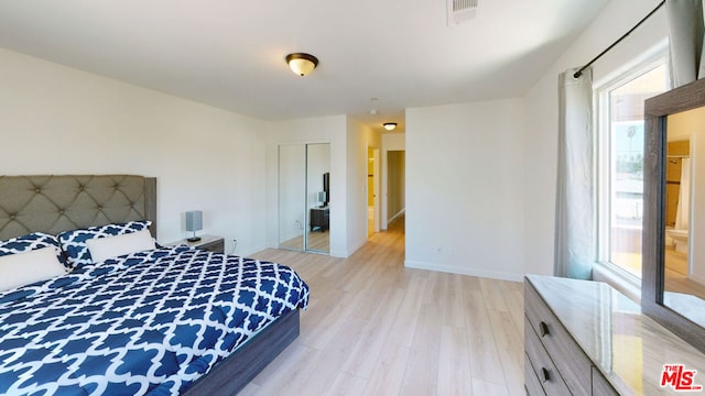 bedroom featuring a closet and light hardwood / wood-style flooring