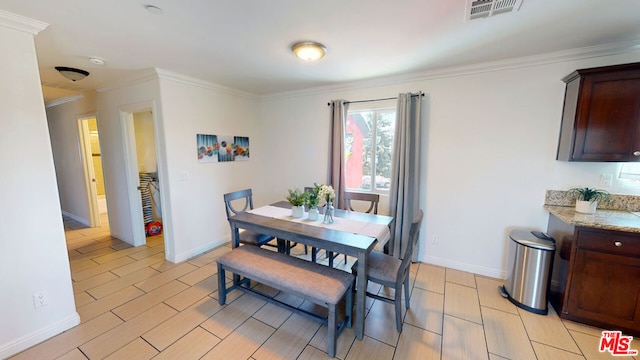 dining space featuring ornamental molding