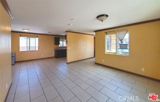 tiled empty room featuring ornamental molding