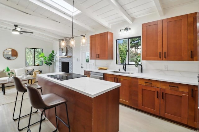 kitchen with a breakfast bar, pendant lighting, sink, stainless steel dishwasher, and black electric cooktop