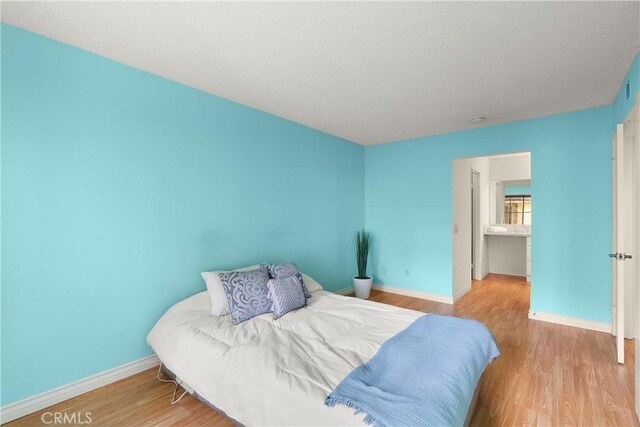 bedroom with light hardwood / wood-style floors