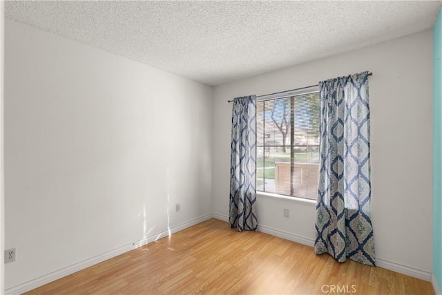 empty room featuring hardwood / wood-style floors and a textured ceiling