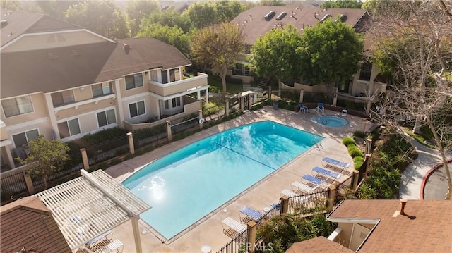 view of swimming pool with a patio and a pergola