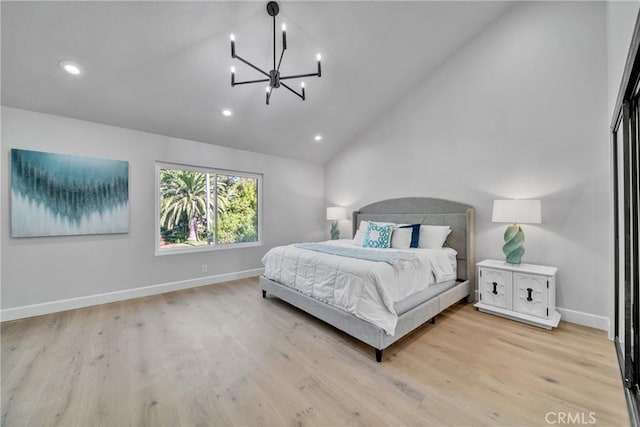 bedroom with lofted ceiling, light wood-type flooring, and a notable chandelier