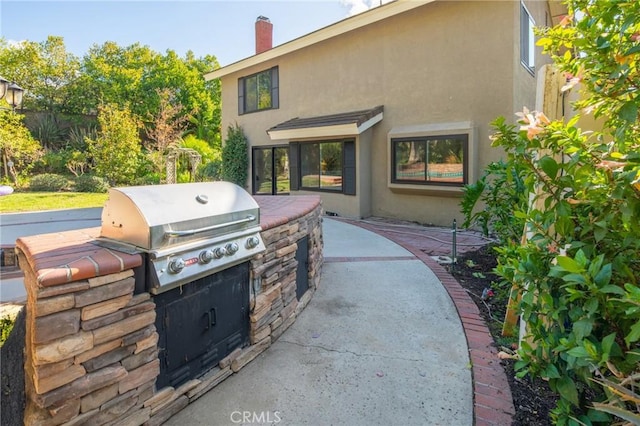 view of patio / terrace with an outdoor kitchen and a grill