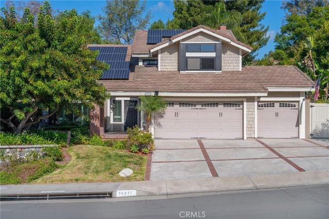 view of front of house featuring a garage and solar panels