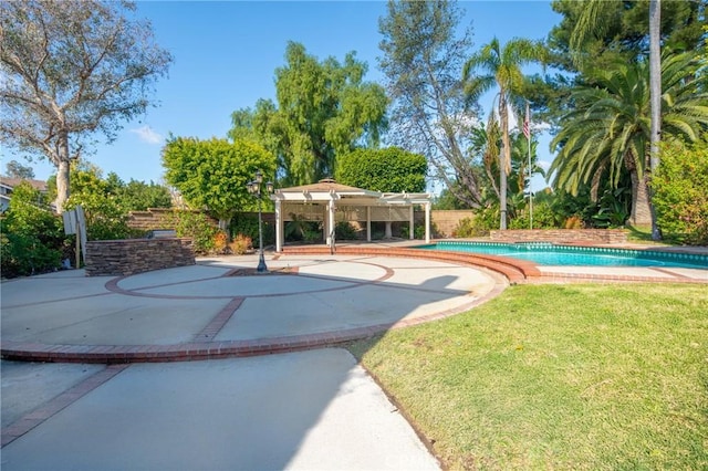 view of pool with a yard and a pergola