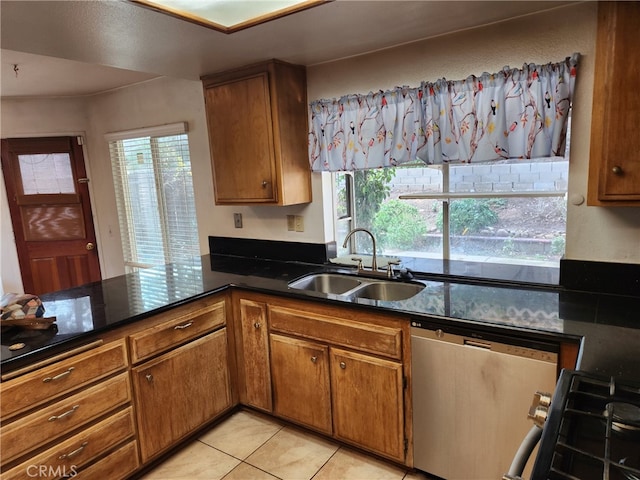 kitchen featuring stainless steel appliances, light tile patterned flooring, sink, and a wealth of natural light