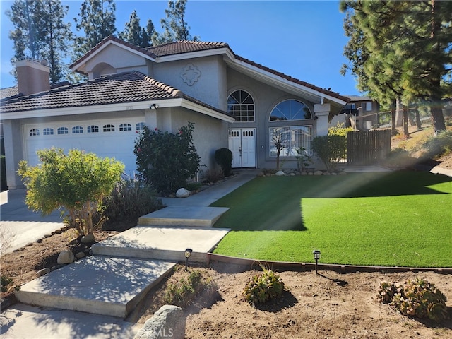 view of front facade featuring a garage and a front lawn