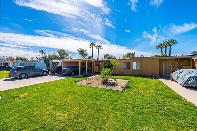 single story home with stucco siding, driveway, an attached carport, and a front yard