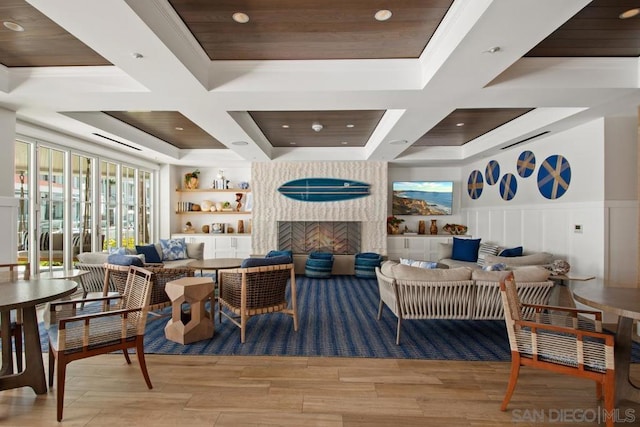 living room with coffered ceiling and light hardwood / wood-style floors