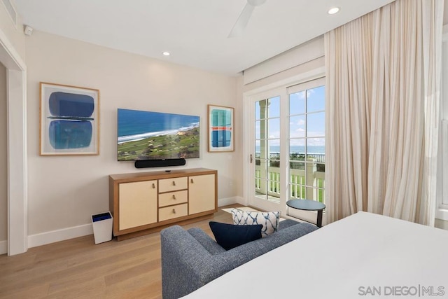 bedroom with light hardwood / wood-style flooring, access to outside, and ceiling fan